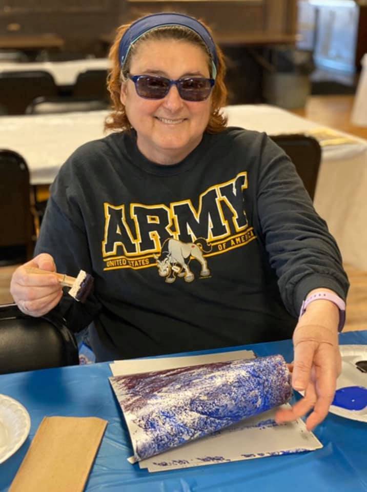 army veteran with art piece she created.